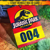 Doctor Collector Jurassic Park staff vehicle ID card marked 004 with iconic dinosaur logo on textured natural ground background