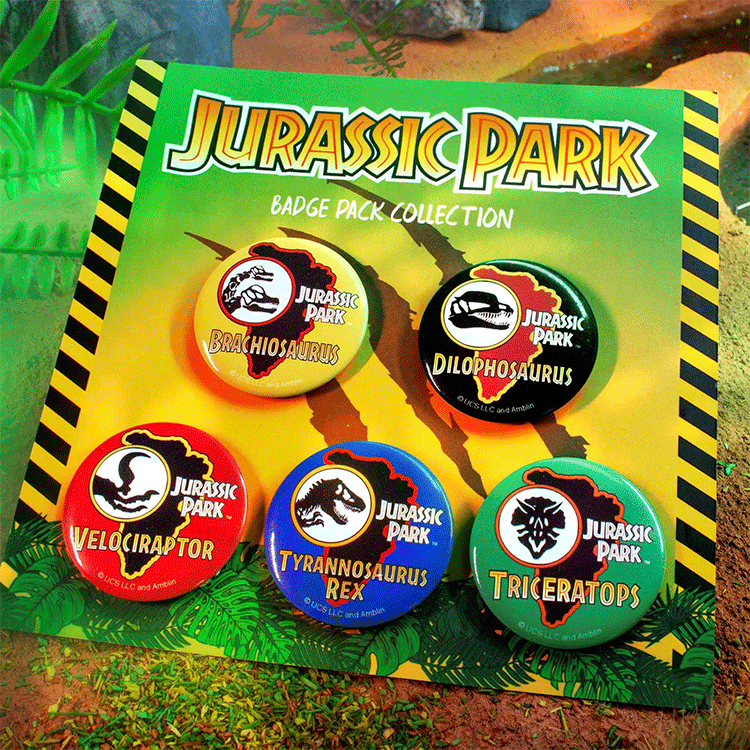 Doctor Collector Jurassic Park badge set featuring colorful Brachiosaurus, Dilophosaurus, Velociraptor, T-Rex, and Triceratops pins