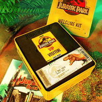 Doctor Collector Jurassic Park Ultimate Welcome Kit tin with VIP pass, dinosaur ticket, and iconic themed collectibles inside