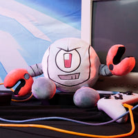 Kaboodle Plush Gameoverse Official Collectible Figure by Glitch Productions posed with retro gaming controllers and monitor.