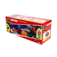 Red MASK Gator vehicle toy in illustrated packaging with an action figure and transforming vehicle scene
