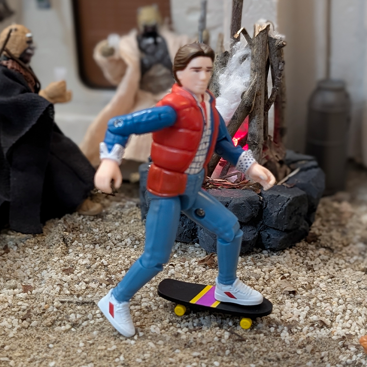 Super7 Back To The Future 3 3/4-inch Marty McFly figure on skateboard with detailed campfire and desert diorama background