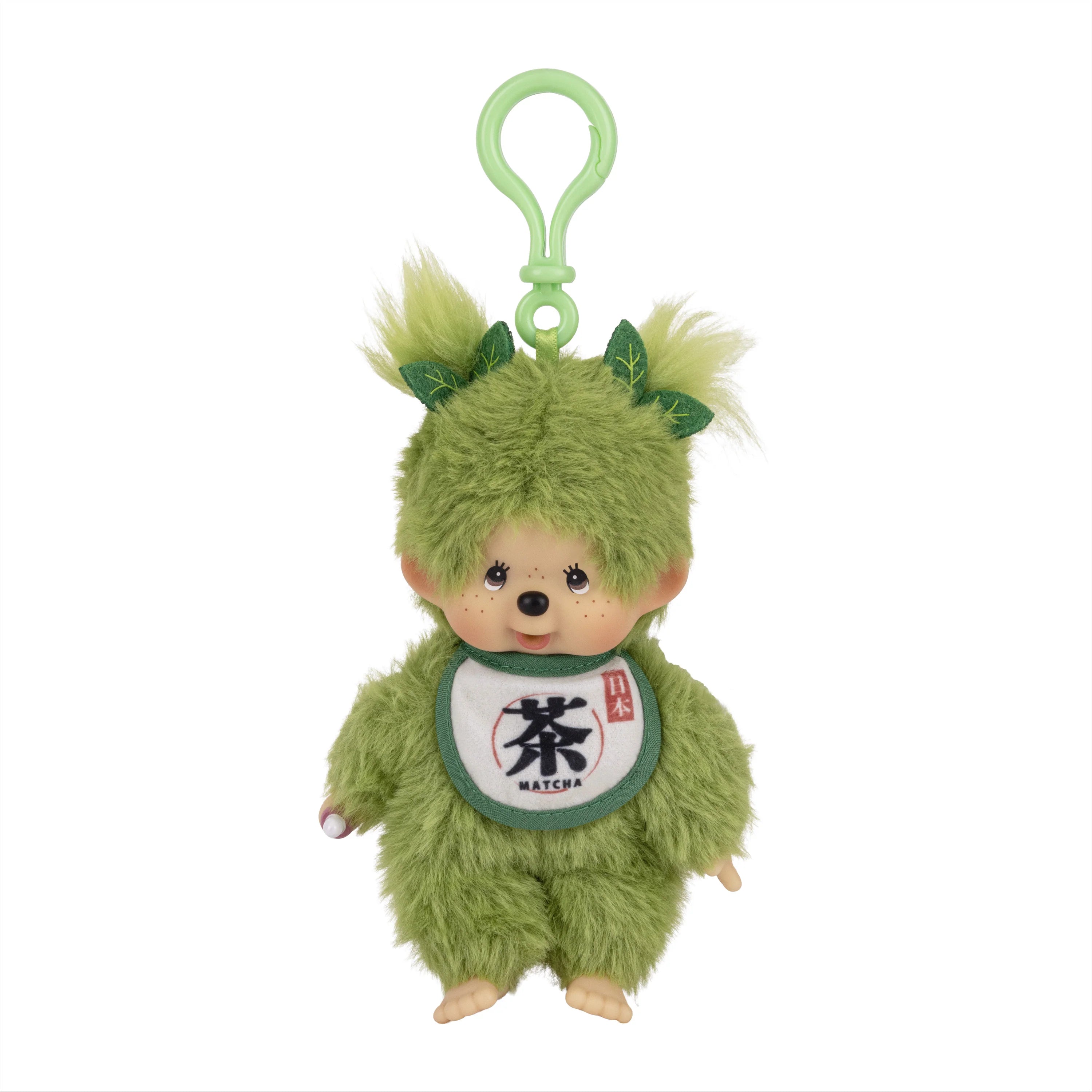 Green furry plush character with a loop, leaf-like ears, and a matcha bib