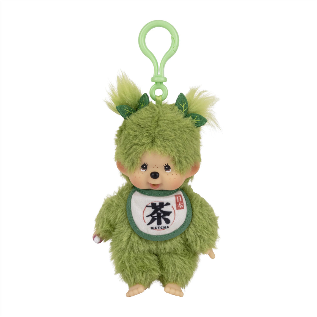 Green furry plush character with a loop, leaf-like ears, and a matcha bib