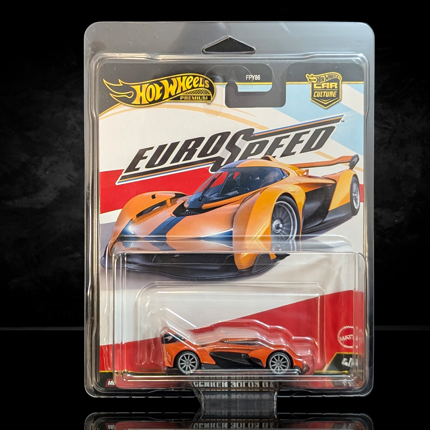 Hot Wheels Premium Euro Speed die-cast car in orange with black stripe and Real Riders wheels in collector blister packaging