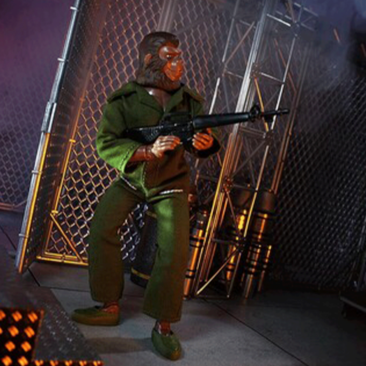 Mego 8-inch retro ape action figure in green military outfit holding rifle posed in industrial metal fence setting