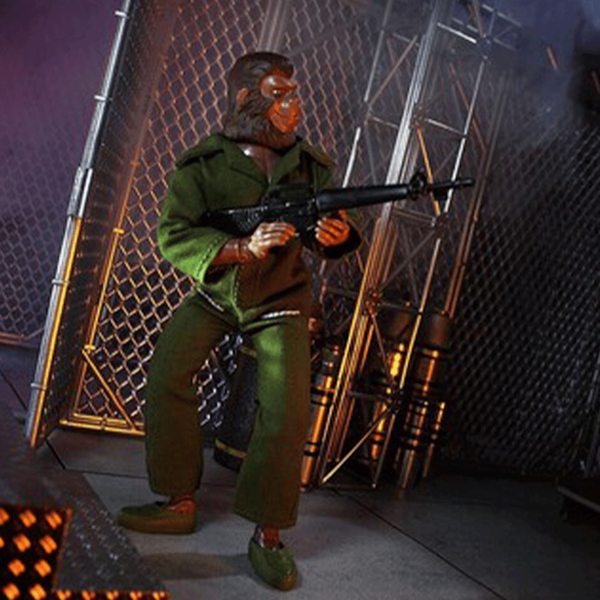 Mego 8-inch retro ape action figure in green military outfit holding rifle posed in industrial metal fence setting