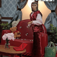 Mego 8-inch retro ape figure dressed in red velvet vest and pants posed in detailed vintage living room setting