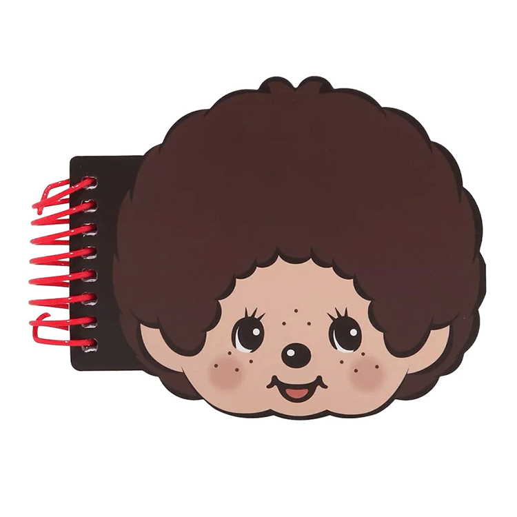 Go Figment Monchhichi face-shaped spiral notebook with brown hair and red binding on white background