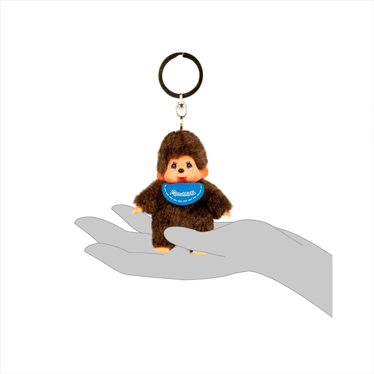 Sekiguchi Monchhichi 4-inch plush keychain held in hand with soft brown fur and blue bib accessory