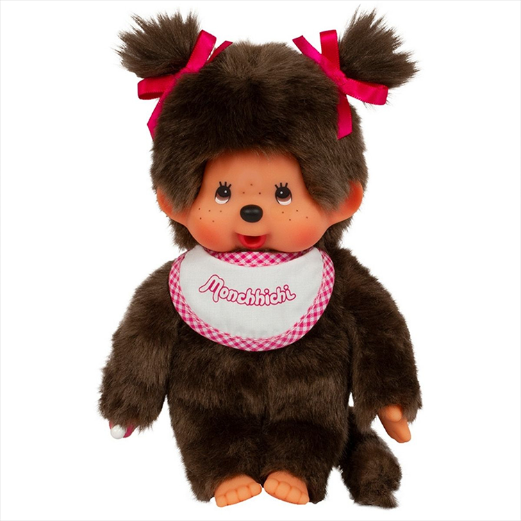 Sekiguchi Monchhichi classic 7-inch girl plush with brown fur, pink bows, and white-pink bib sitting upright.