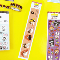PipSticks Monchhichi PVC sticker strip featuring sushi-themed kawaii characters on a beige background with gold foil accents