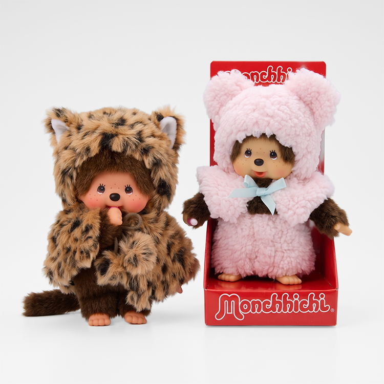 Two Monchhichi dolls in animal costumes, one leopard print and one pink bear outfit in red packaging