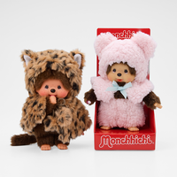 Two Monchhichi dolls in animal costumes, one leopard print and one pink bear outfit in red packaging