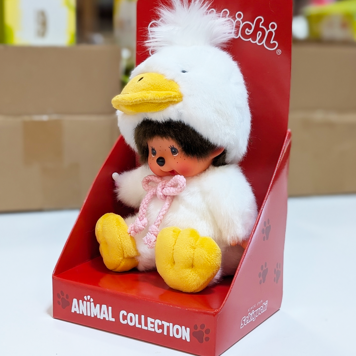 Official Sekiguchi Monchhichi 8-inch Animal Friends Duck plush doll wearing a yellow duckling hood, often searched as Monchichi.