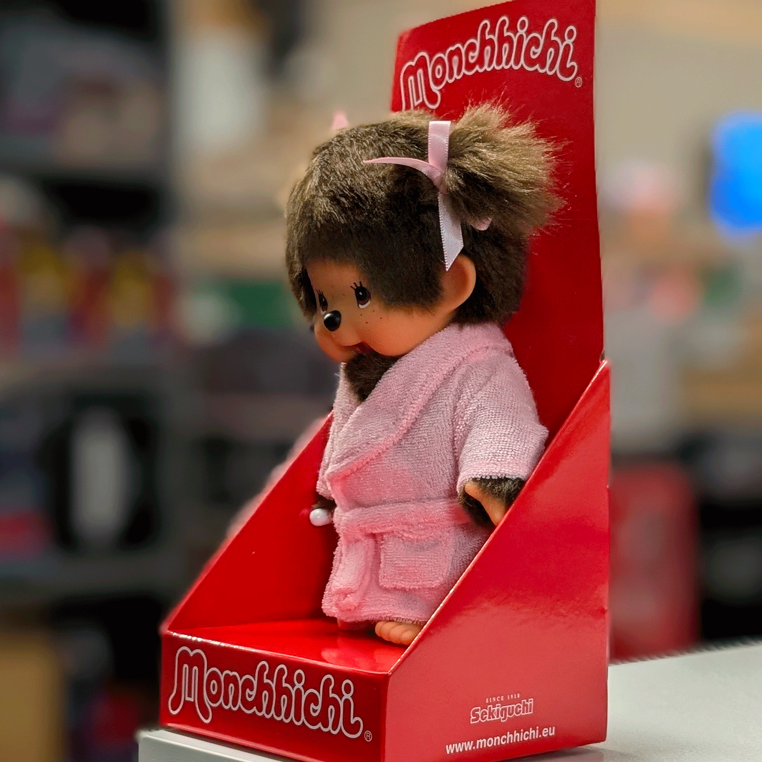 8-inch Sekiguchi Monchhichi girl doll in pink bathrobe with thumb in mouth in original red packaging box