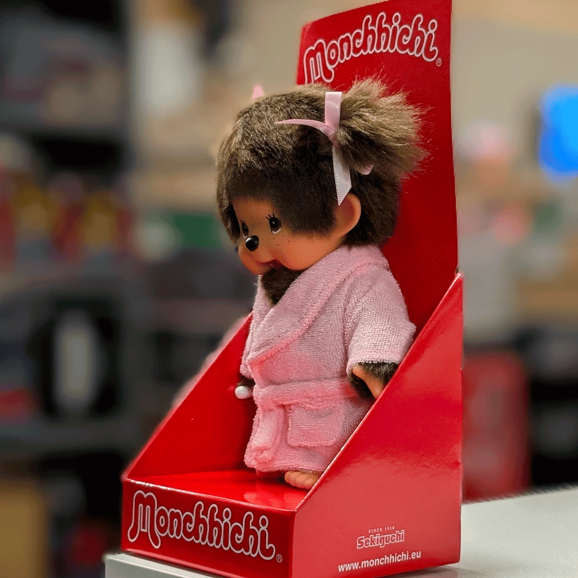 8-inch Sekiguchi Monchhichi girl doll in pink bathrobe with thumb in mouth in original red packaging box