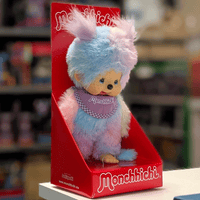 Sekiguchi 8-inch Monchhichi girl plush doll in pastel blue and pink tie-dye fur with purple bib in red display box