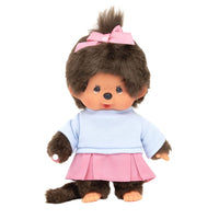 Sekiguchi Monchhichi Girl plush doll in pink pleated skirt, blue shirt, with thumb in mouth and pink ribbon updo