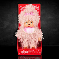 Sekiguchi Monchhichi plush doll with fluffy pink beige fur, gingham bib and bow, in classic thumb-sucking pose