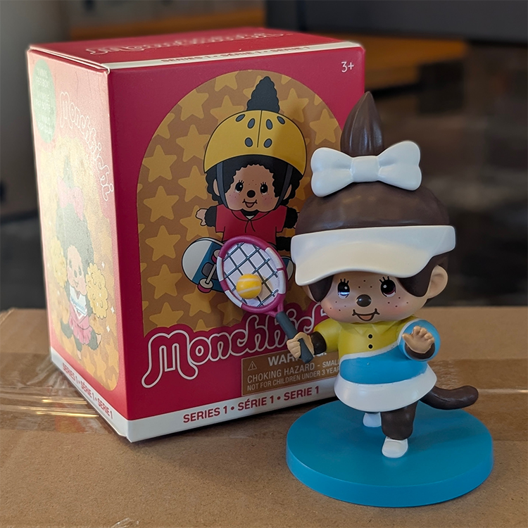Sekiguchi Monchhichi girl tennis player figure with visor and racket on blue base from Series 1 Sports Blind Box