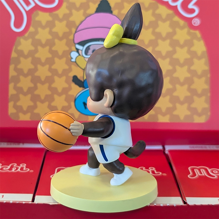 Sekiguchi Girl Monchhichi basketball player vinyl figure in white jersey holding basketball on yellow base