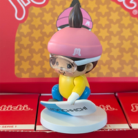 Sekiguchi Monchhichi vinyl figure in skiing outfit with helmet and goggles on white display stand.