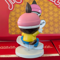 Sekiguchi Monchhichi Boy Snowboarding vinyl figure in yellow jacket and pink helmet on white snow display stand