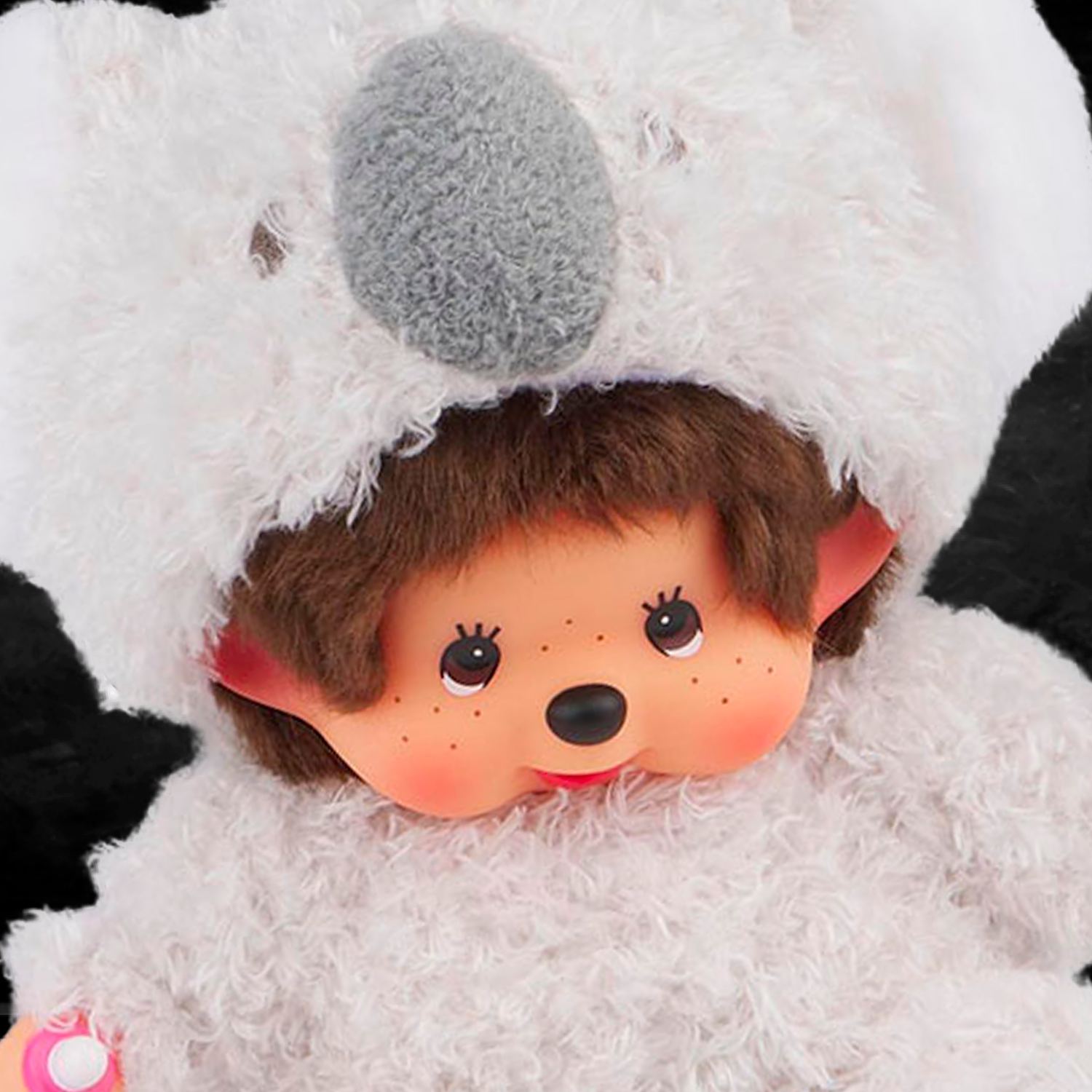 Sekiguchi 8 inch Monchhichi sitting plush doll dressed in fluffy koala costume with thumb in mouth