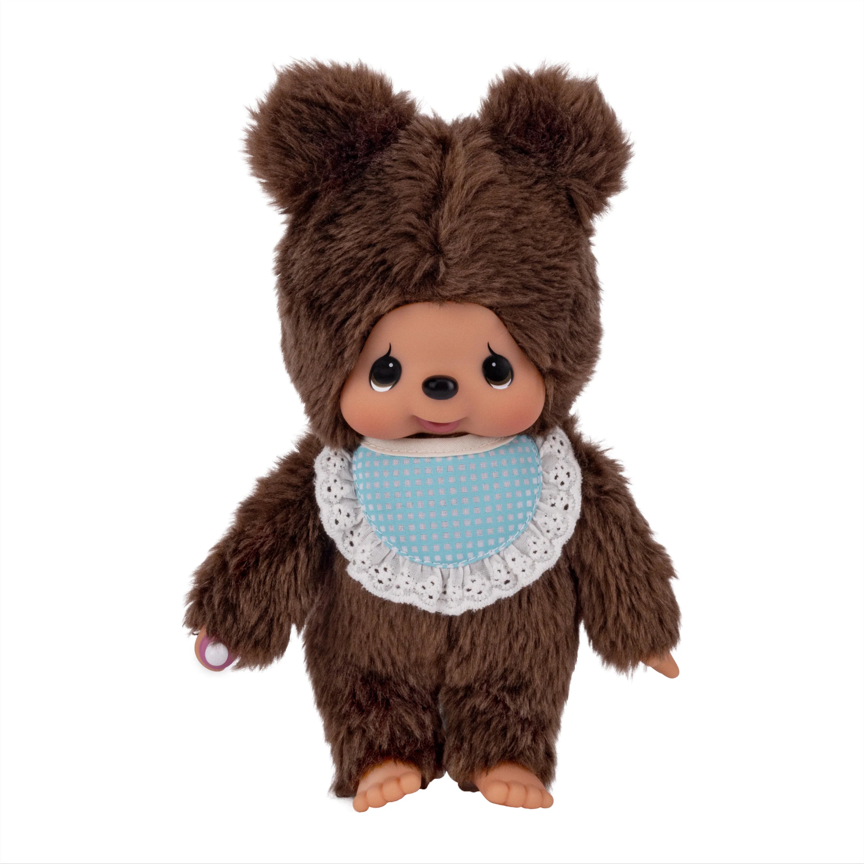 Brown bear Monchhichi doll wearing a blue polka dot bib with lace trim
