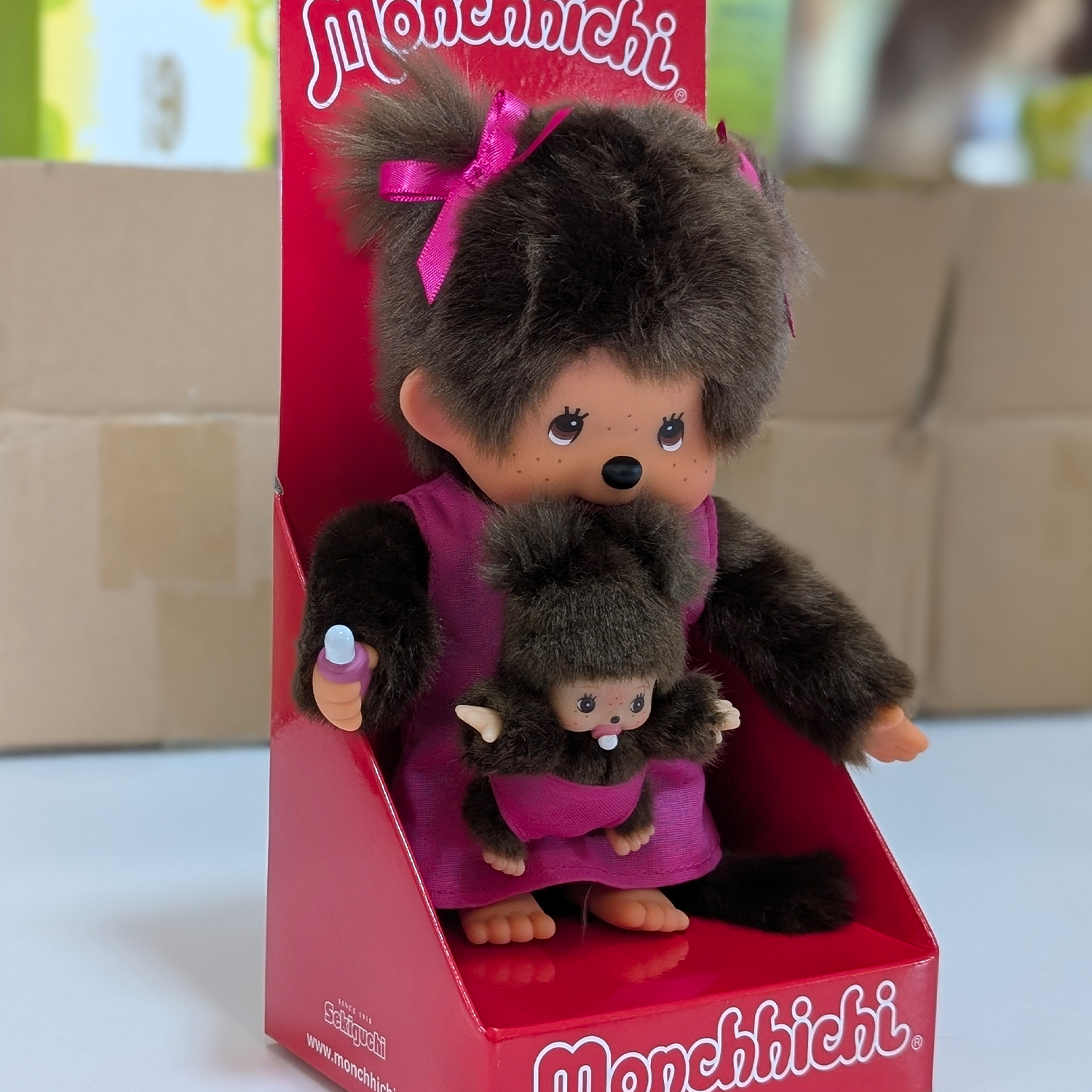 Official Sekiguchi Monchhichi 8-inch Mothercare pink plush doll holding a matching baby monkey, often spelled Monchichi.