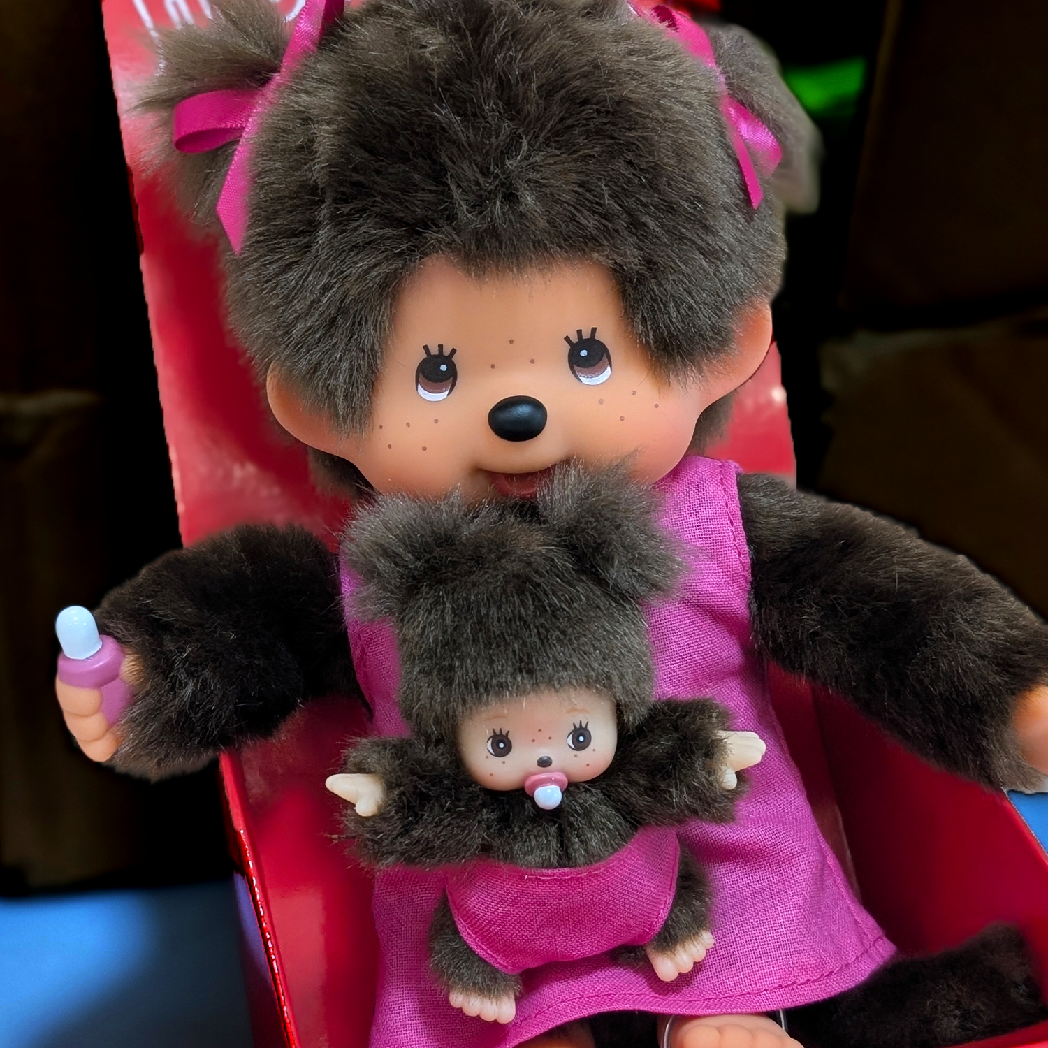 Official Sekiguchi Monchhichi 8-inch Mothercare pink plush doll holding a matching baby monkey, often spelled Monchichi.