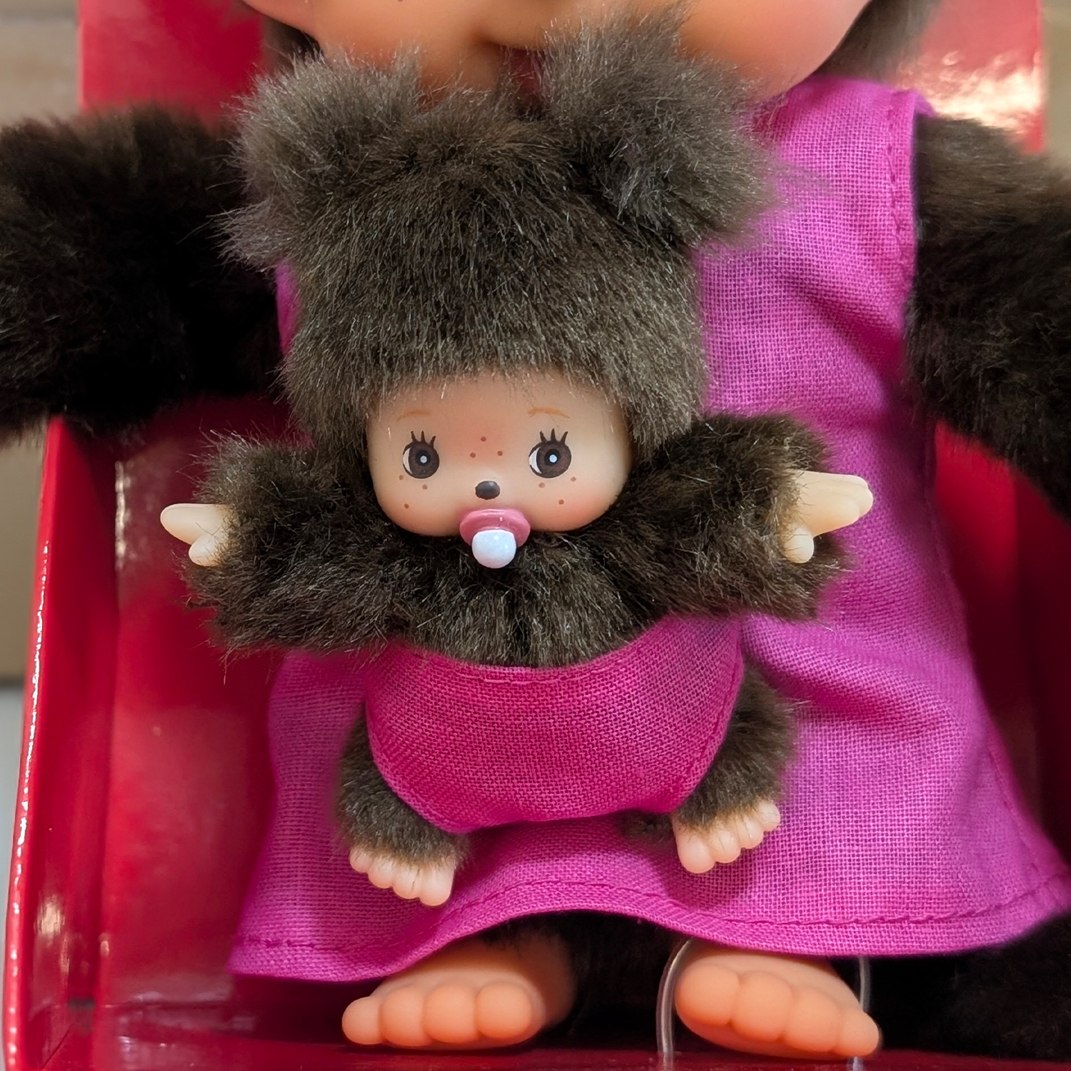 Official Sekiguchi Monchhichi 8-inch Mothercare pink plush doll holding a matching baby monkey, often spelled Monchichi.
