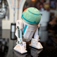 Kenner NO-AH Star Wars Droid Factory loose astromech figure with weathered paint and articulated dome on black surface