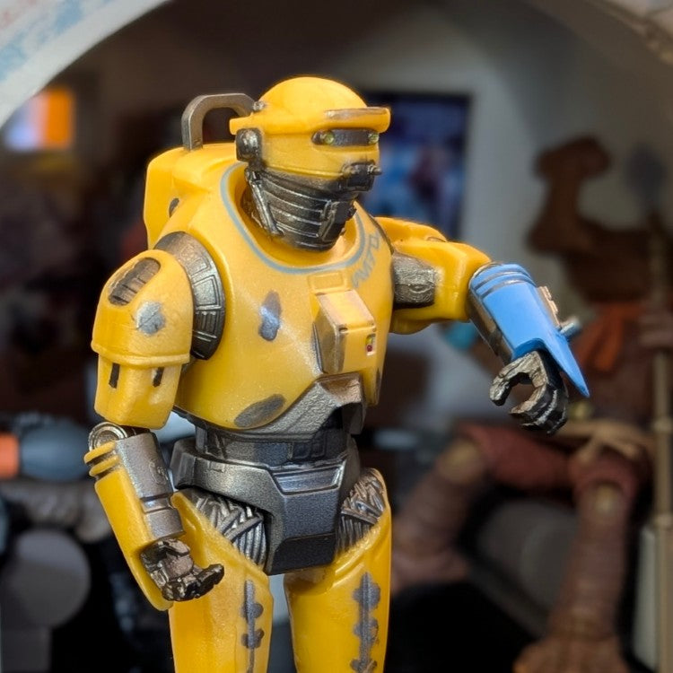 Hasbro NED-B Star Wars 3.75 inch Droid Factory action figure in yellow with blue forearm detail on display