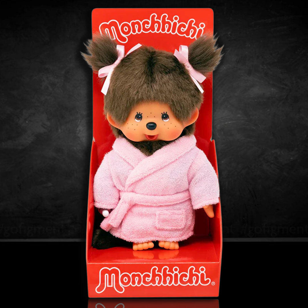 Sekiguchi Monchhichi girl monkey plush in pink bathrobe with twin pigtails displayed in red packaging