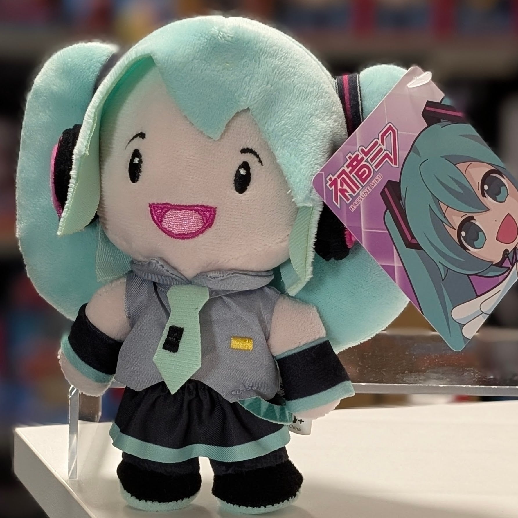 UCC 6-inch Hatsune Miku plush with soft teal twin tails and smiling embroidered face wearing signature outfit