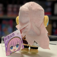 UCC 6-inch Megurine Luka plush viewed from the back with pink hair and yellow headphones holding a tag