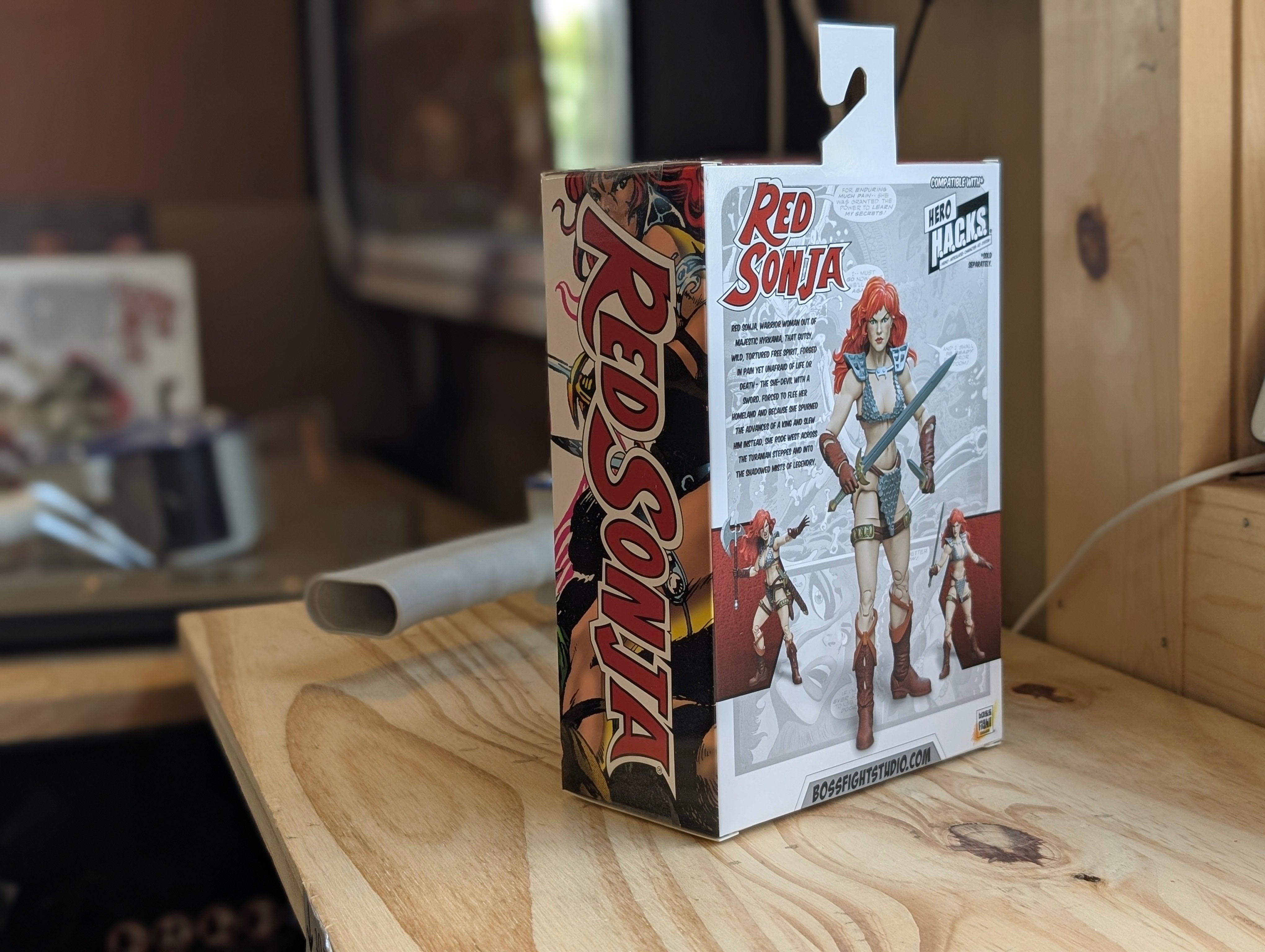 Box of Red Sonja action figure on a wooden surface