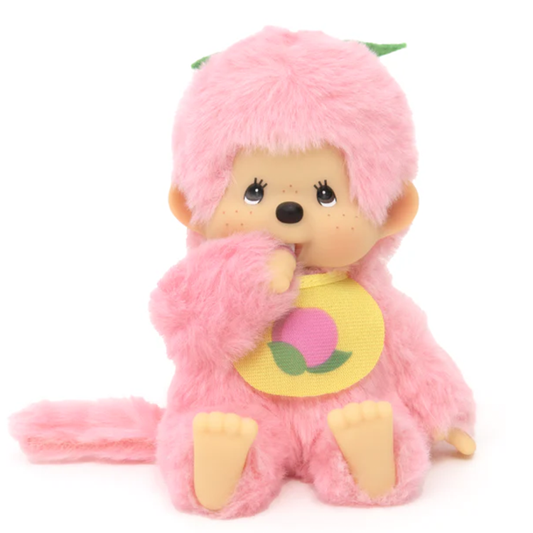 Sekiguchi Monchhichi plush in peach pink with soft body and detailed plastic face, hands, and feet sitting on white background