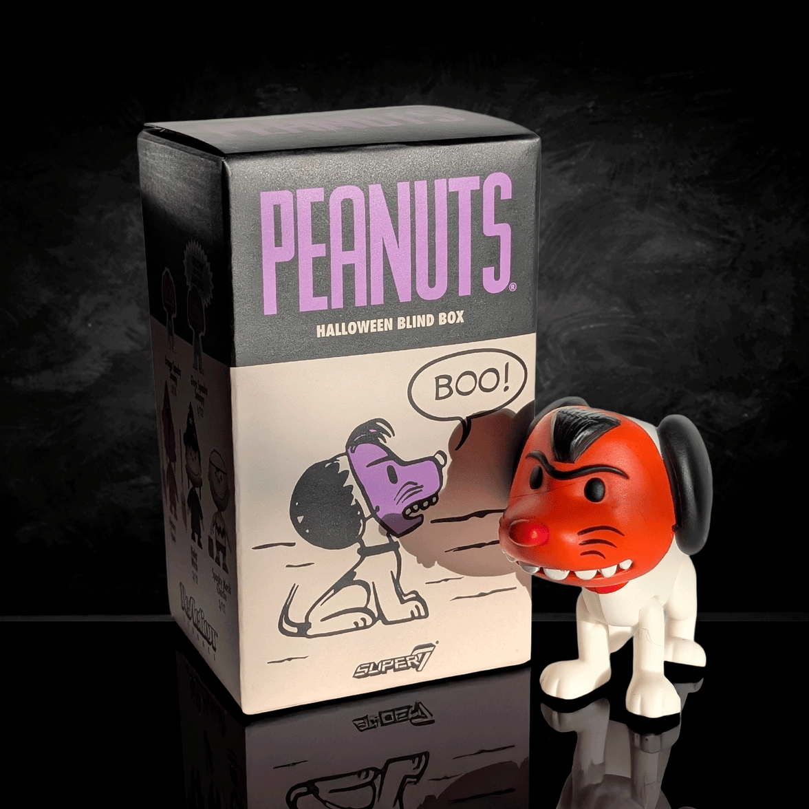 Peanuts Halloween blind box and vinyl figure of Snoopy as the Red Devil, by Go Figment, against a dark background
