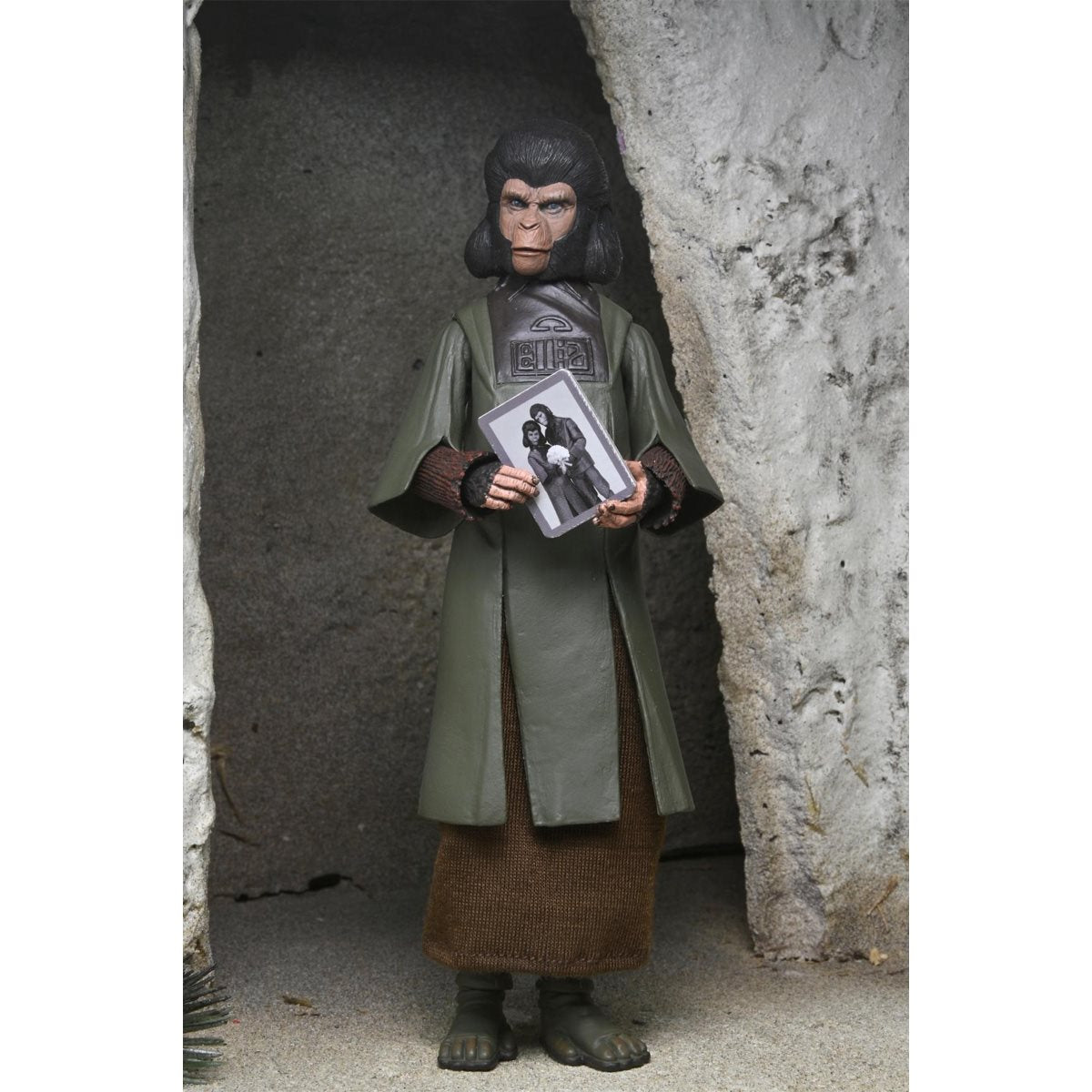 Zira Planet of the Apes Legacy Series 7-Inch Scale Action Figure by Neca posed holding a photo inside a cave setting