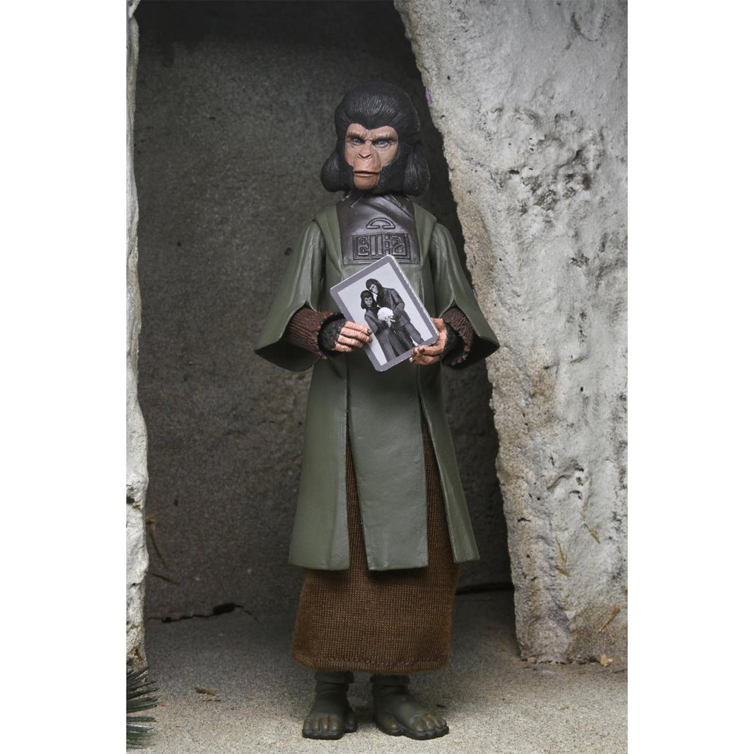 Zira Planet of the Apes Legacy Series 7-Inch Scale Action Figure by Neca posed holding a photo inside a cave setting