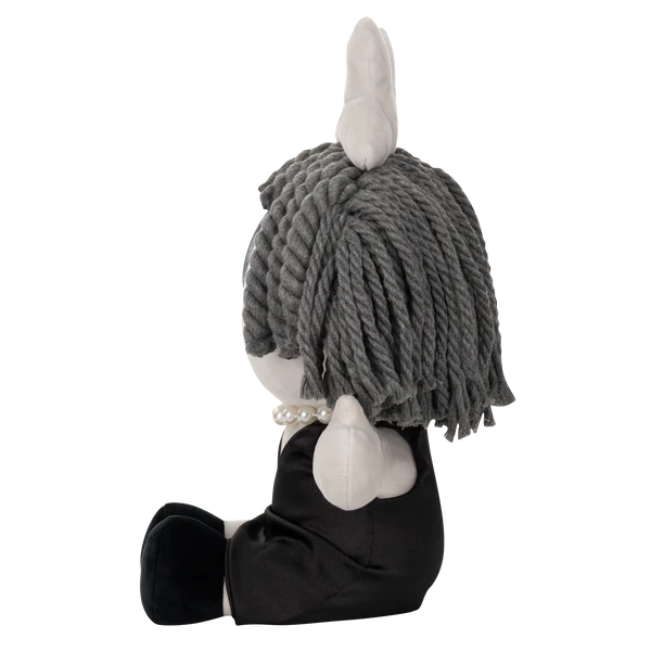 Glitch Ragatha plush doll from The Amazing Digital Circus with gray yarn hair, black dress, and pearl necklace sitting in profile