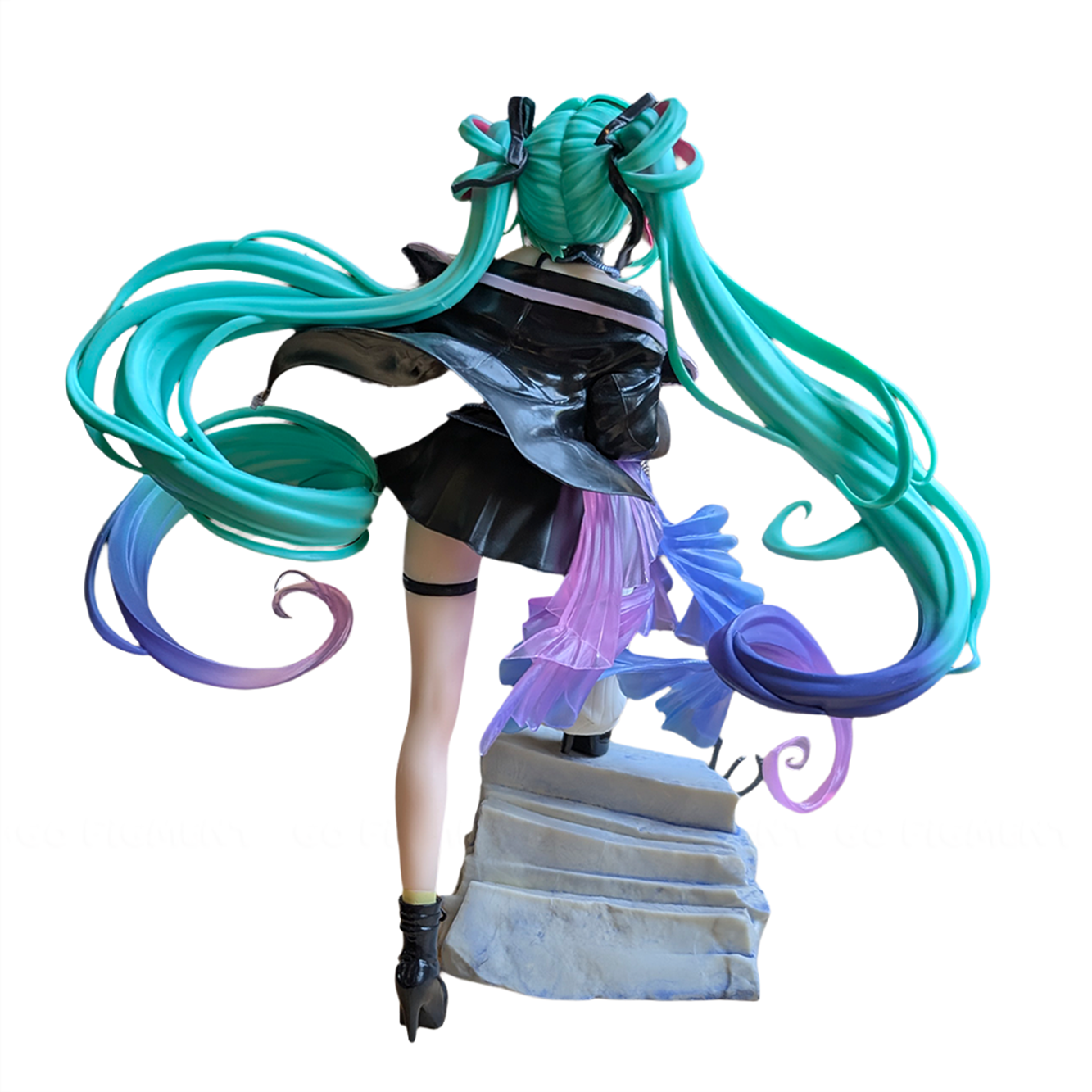 Anime-style figure with long teal and purple twin tails wearing a black outfit standing on stone steps