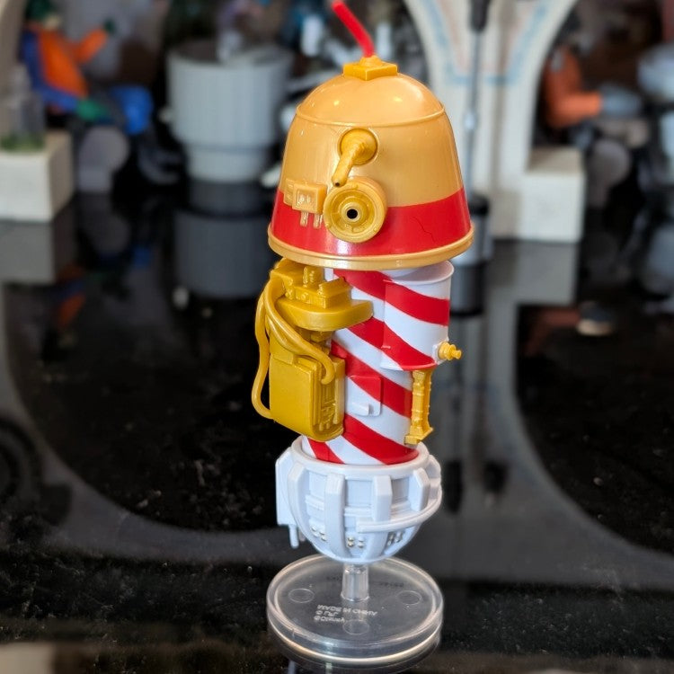 Kenner Star Wars R1 Christmas Bell Droid action figure with red and white candy cane stripes on display stand