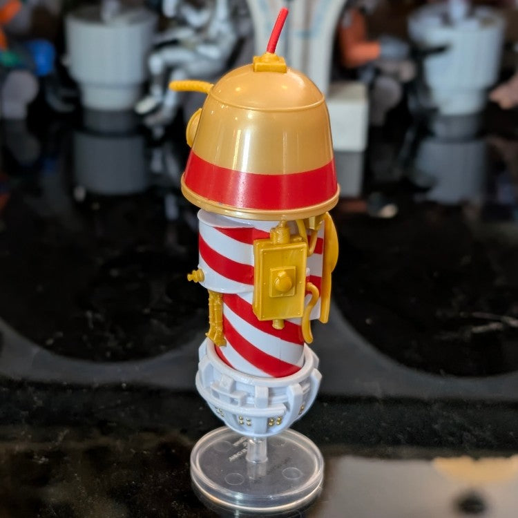 Kenner R1 Christmas Bell Droid action figure with festive red and white stripes on display stand.