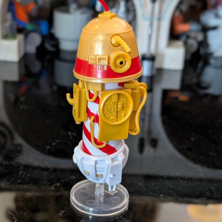 Loose Kenner R1 Christmas Bell Droid action figure standing on clear display stand with festive red and white details