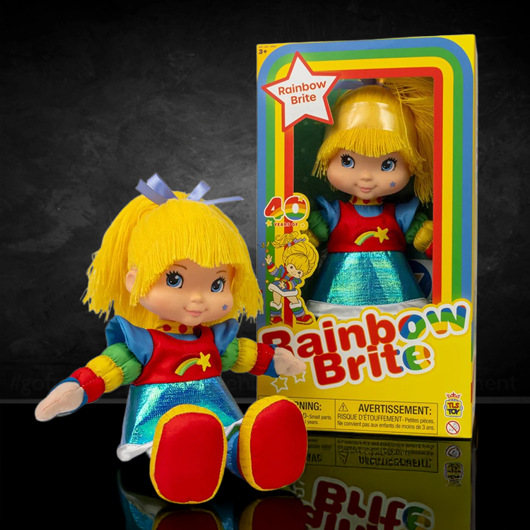Rainbow Brite plush doll with bright yellow hair and colorful outfit sitting next to its original packaging box.