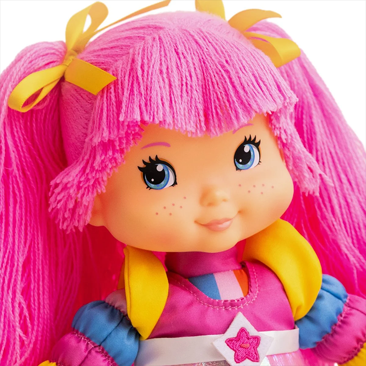 Close-up of Tickled Pink doll with pink yarn hair and colorful outfit from The Loyal Subjects Rainbow Brite collection